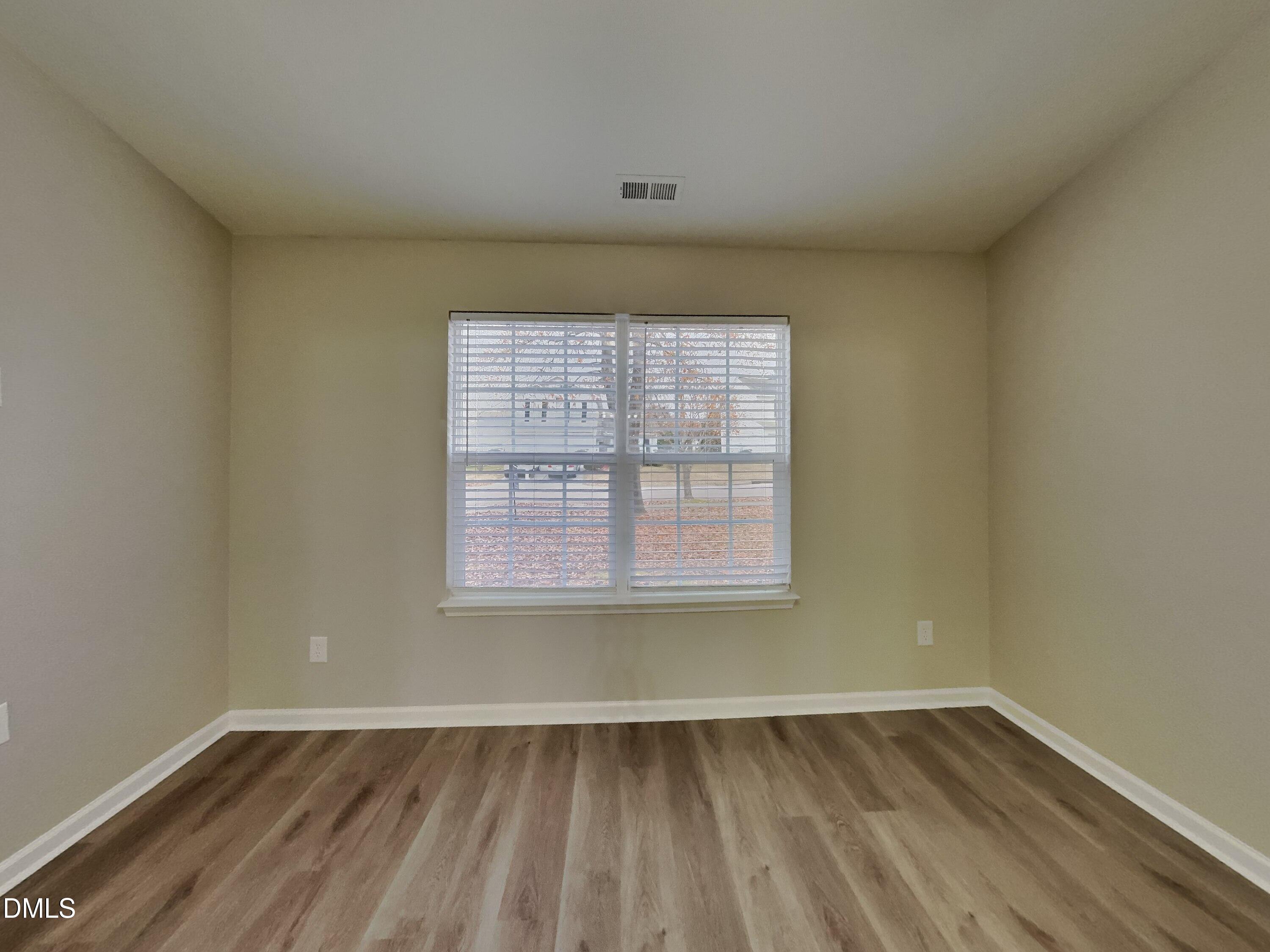3665 Watkins Ridge Court Raleigh, NC 27616 - Photo 5 of 15 an empty room with wooden floor and windows