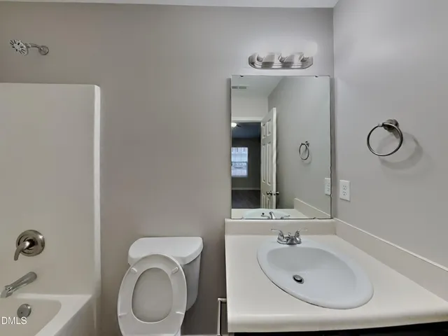 a bathroom with a sink a toilet and bathtub