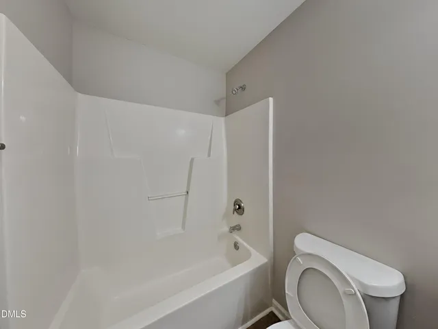 a bathroom with a toilet and a bathtub