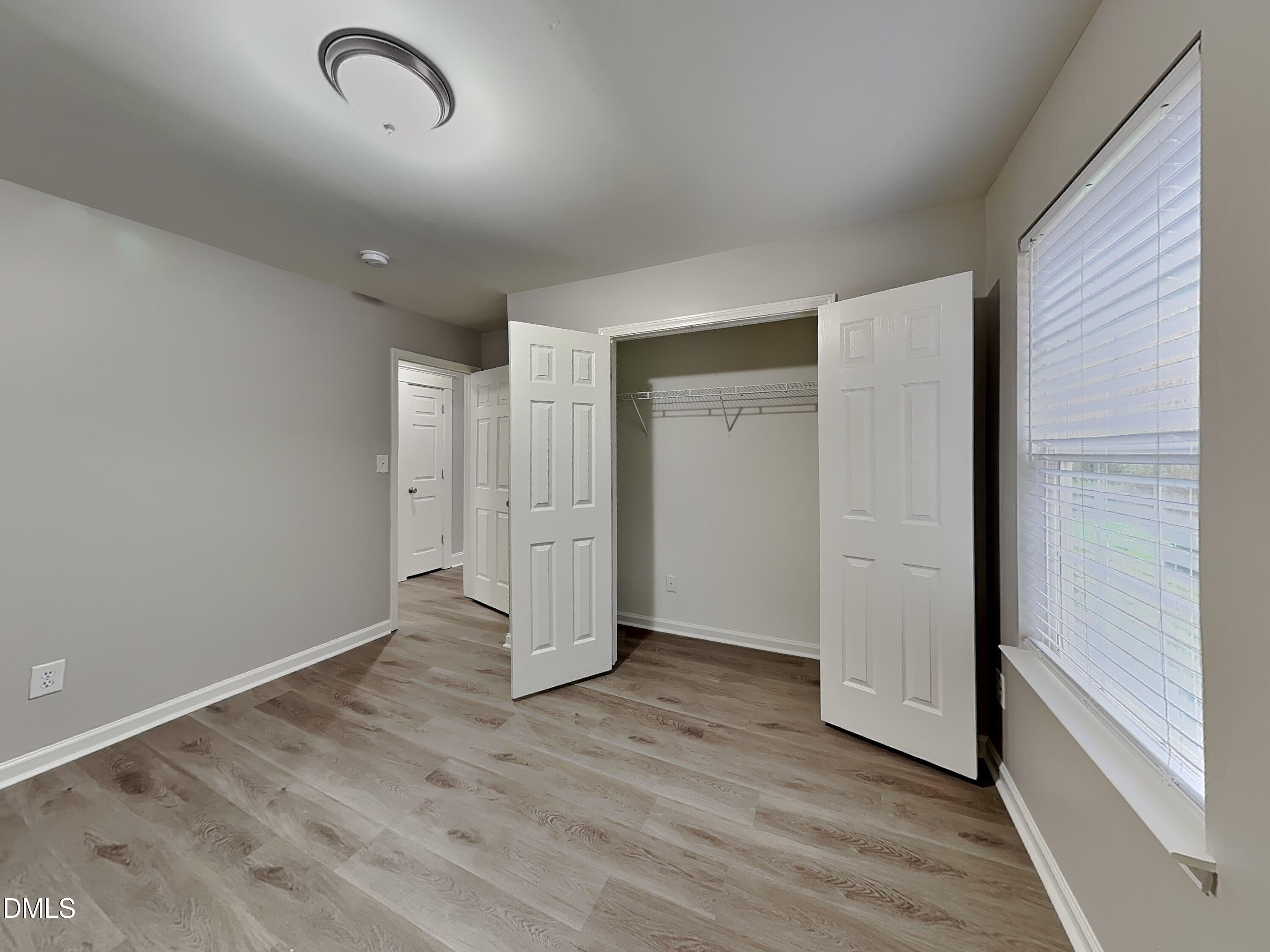 3665 Watkins Ridge Court Raleigh, NC 27616 - Photo 10 of 15 wooden floor in an empty room with a window