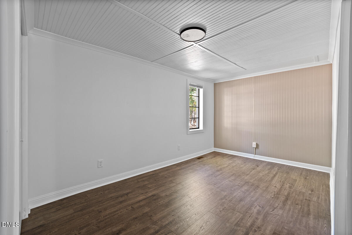 7700 Humie Olive Road Apex, NC 27502 - Photo 12 of 13 an empty room with wooden floor and windows