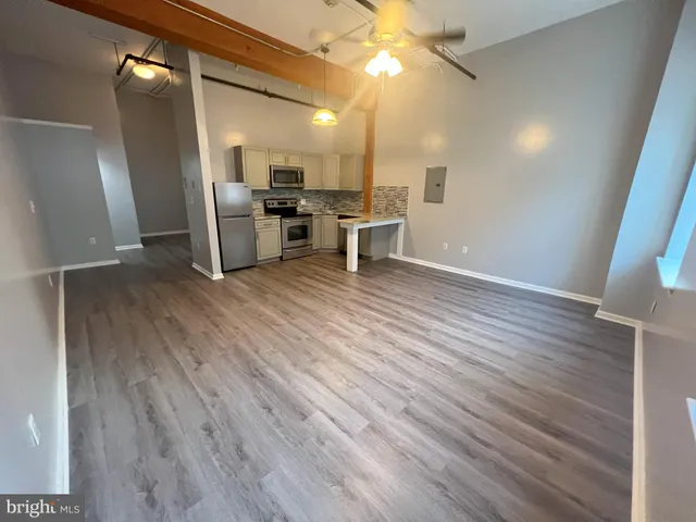 a view of a kitchen with a sink and a refrigerator