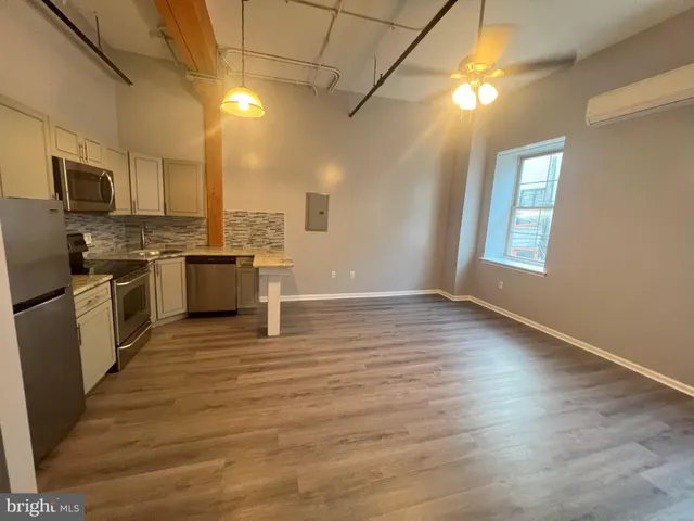 a kitchen with stainless steel appliances granite countertop a sink a stove top oven a counter space and cabinets