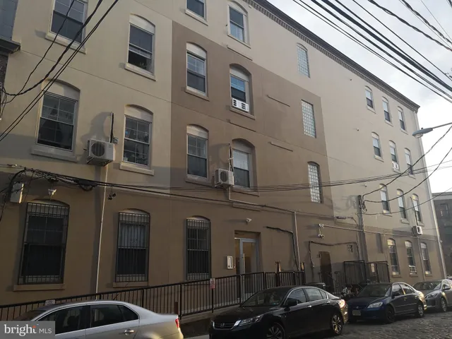 a couple of cars parked in front of a building