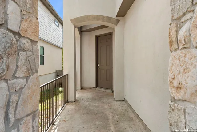 a view of a porch with a wooden door and deck