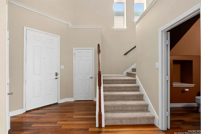 a view of an entryway with wooden floor and door
