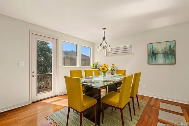 a view of a dining room with furniture wooden floor and chandelier