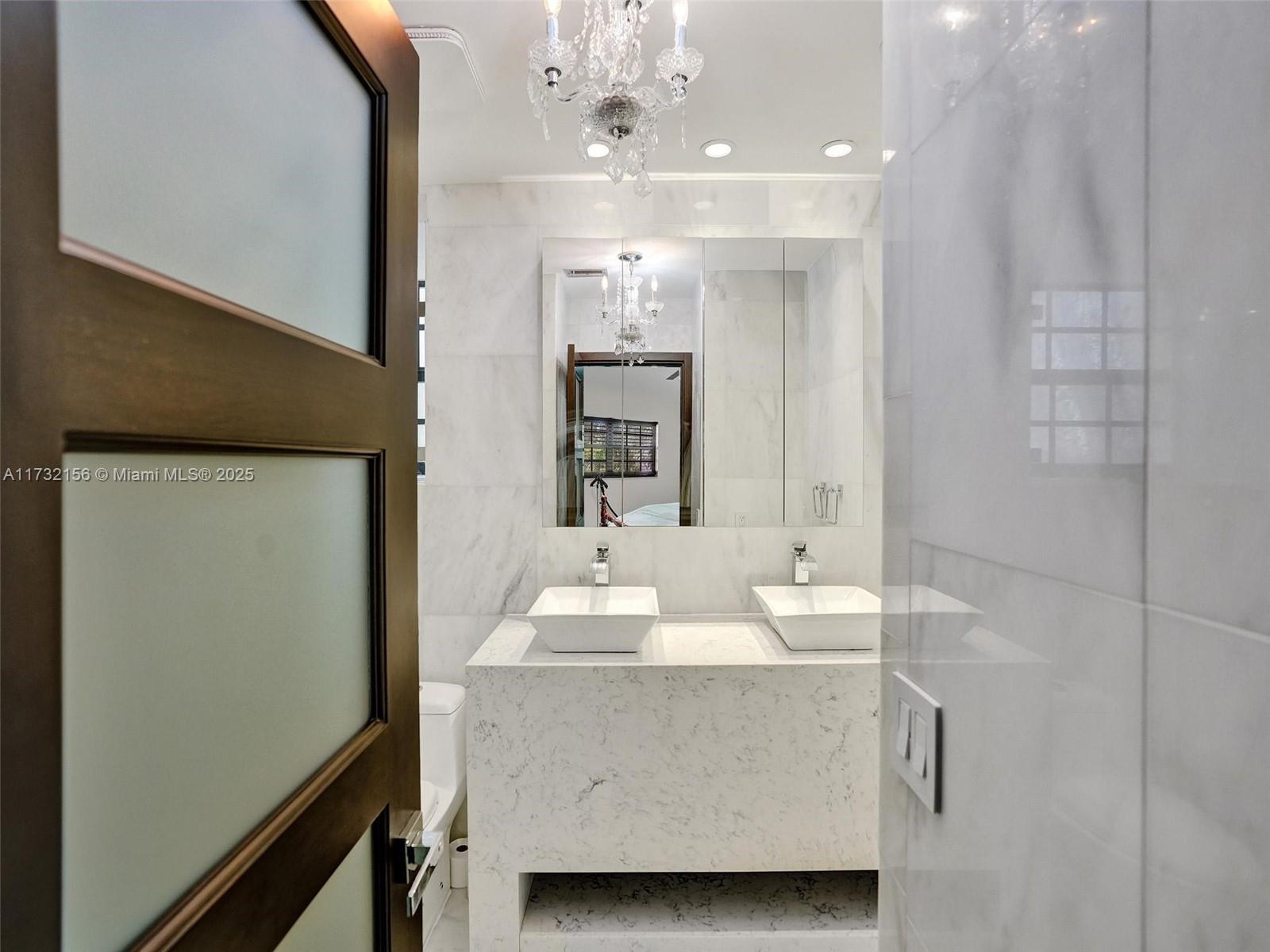 3507 Green Leaf Circle, Unit 2004 Hollywood, FL 33021 - Photo 22 of 33 a bathroom with a sink a mirror and a shower