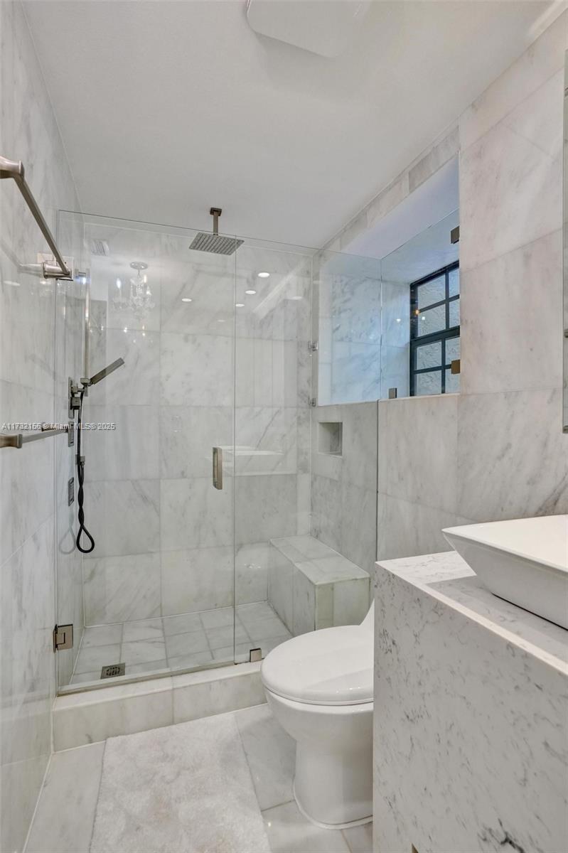 3507 Green Leaf Circle, Unit 2004 Hollywood, FL 33021 - Photo 25 of 33 a bathroom with a shower a toilet and sink