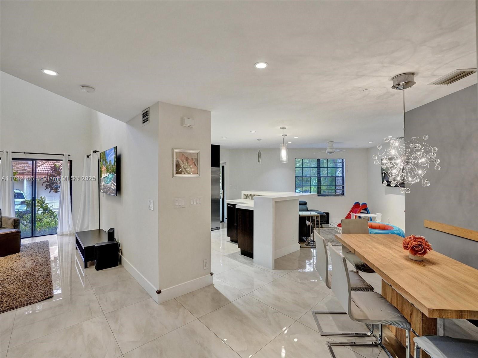 3507 Green Leaf Circle, Unit 2004 Hollywood, FL 33021 - Photo 5 of 33 a living room with furniture and a chandelier