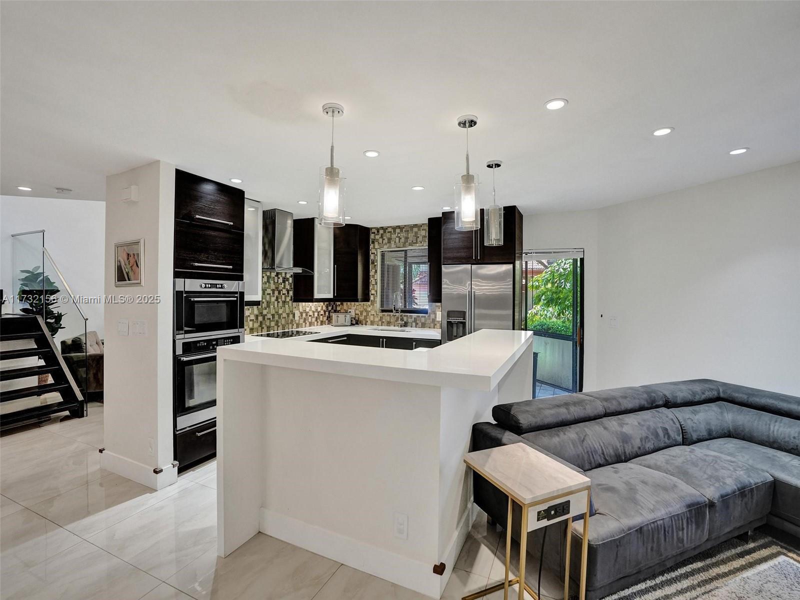 3507 Green Leaf Circle, Unit 2004 Hollywood, FL 33021 - Photo 10 of 33 a living room with furniture and a flat screen tv