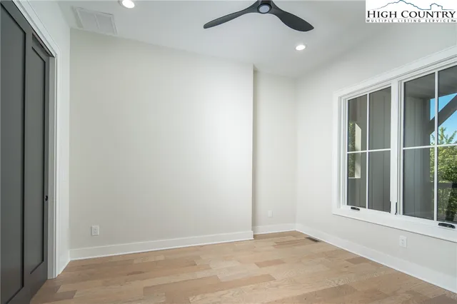 an empty room with windows and entrance