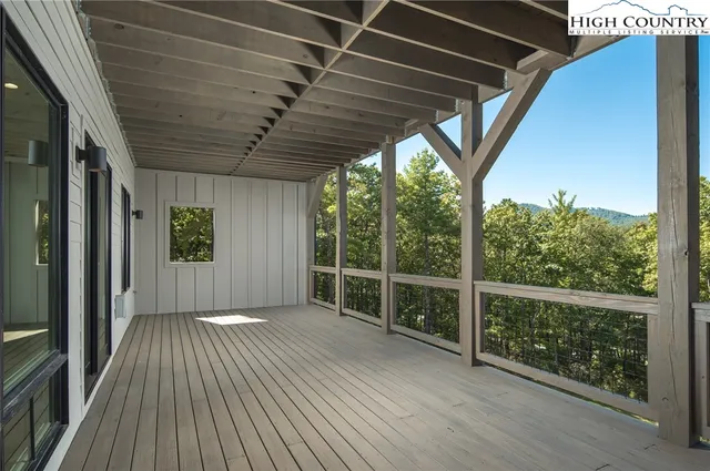 a view of a room with wooden floor and iron stairs