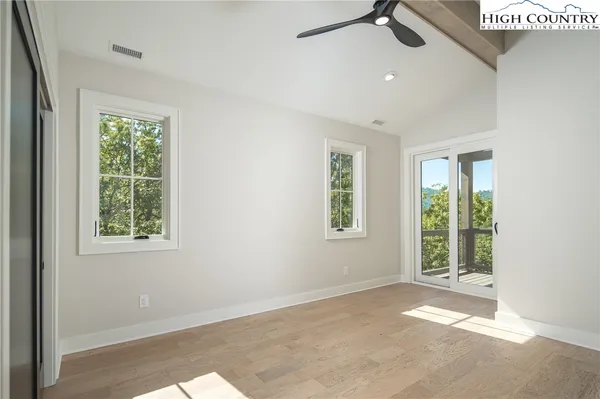 an empty room with windows and closet