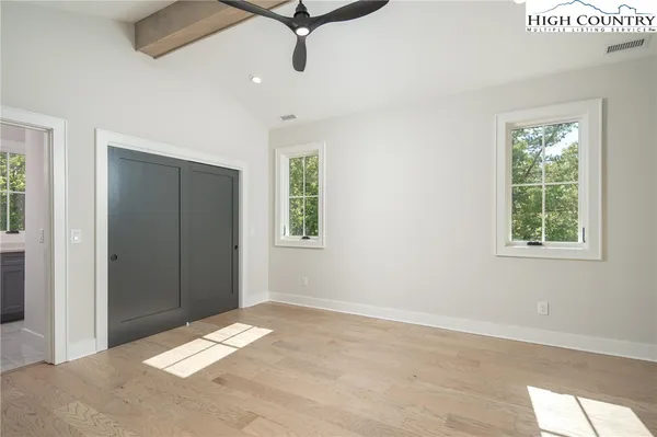 a view of a room with a window and ceiling fan