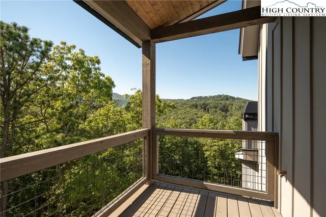 a view of a balcony with wooden floor
