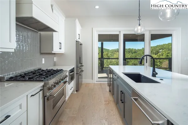 a kitchen with granite countertop a sink and a stove