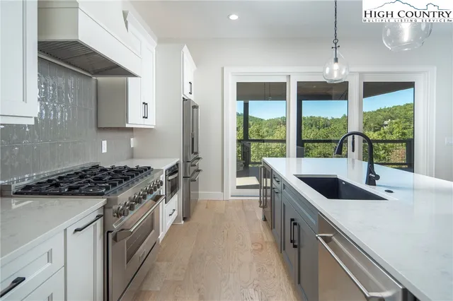 a kitchen with granite countertop a sink and a stove