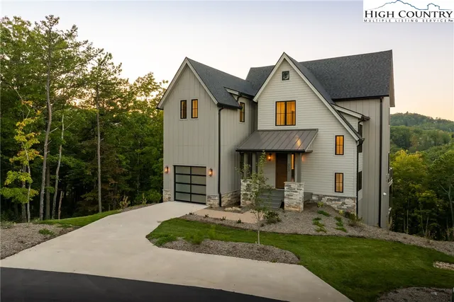 a front view of a house with a yard table and chairs