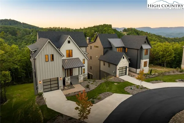 a view of house with backyard and outdoor seating