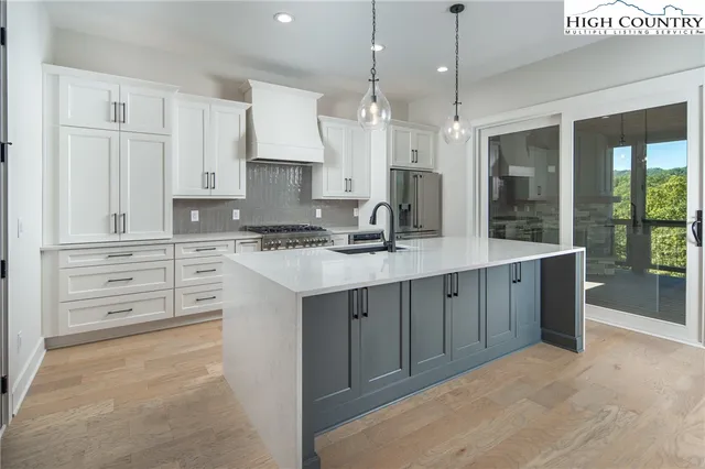 a kitchen with cabinets appliances and a window