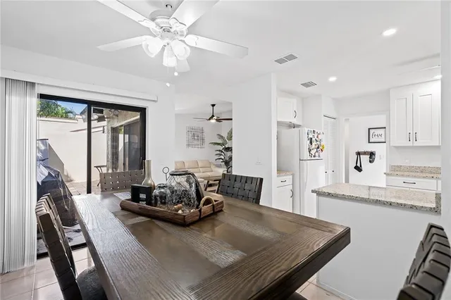 a view of a dining room with furniture a chandelier and wooden floor