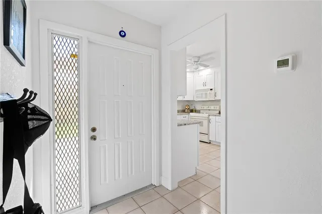 a hallway with white cabinets and wooden floor