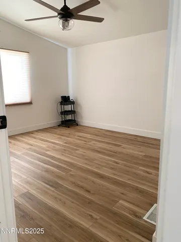 a view of a room with wooden floor