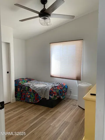 a bedroom with a bed and window