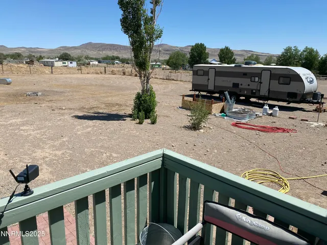 a view of a balcony with chairs and a table