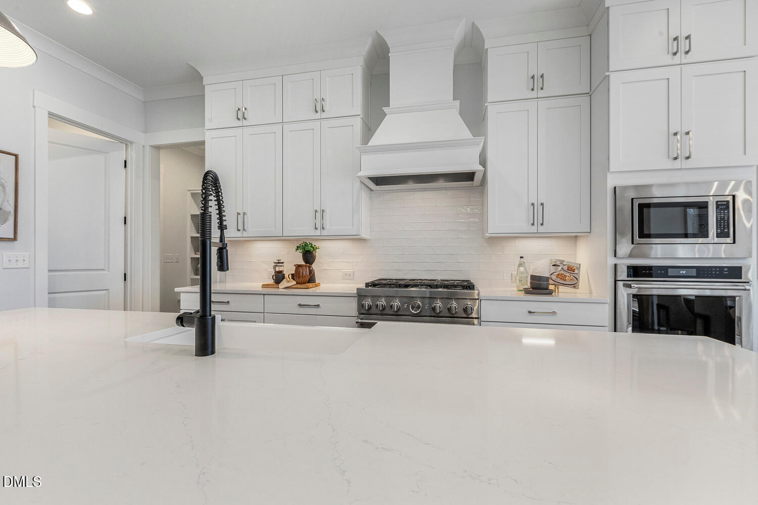 2321 Toll Mill Court Raleigh, NC 27606 - Photo 17 of 82 a kitchen with stainless steel appliances a stove a sink and white cabinets