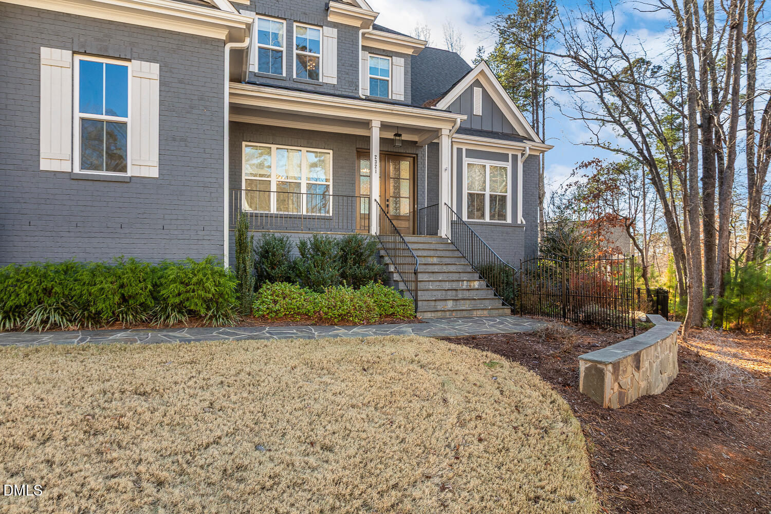 2321 Toll Mill Court Raleigh, NC 27606 - Photo 3 of 82 a view of a brick house with many windows plants and large trees