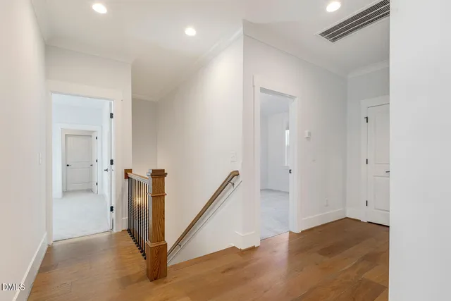 a view of an empty room with chandelier fan
