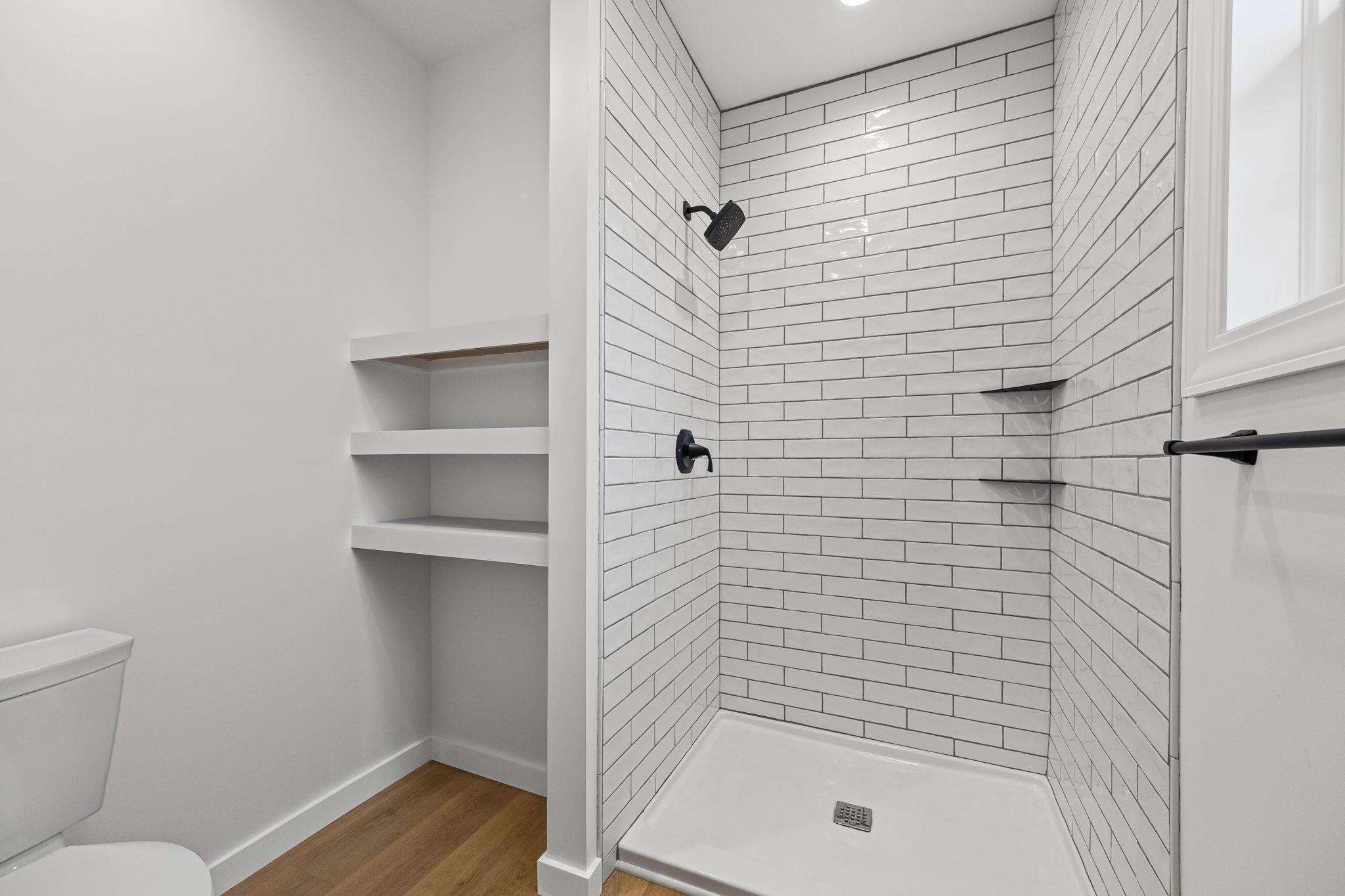 835 Curve Woodville Road Gates, TN 38037 - Photo 17 of 30 Bathroom with a stall shower and dark wood-style floors