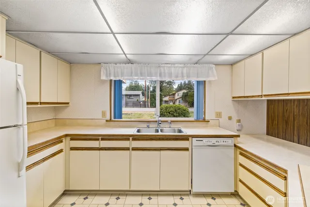 a kitchen with a stove and a refrigerator