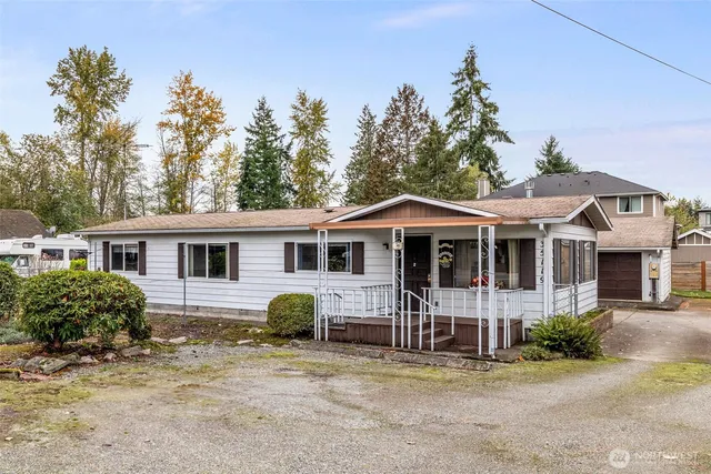 a front view of a house with a garden