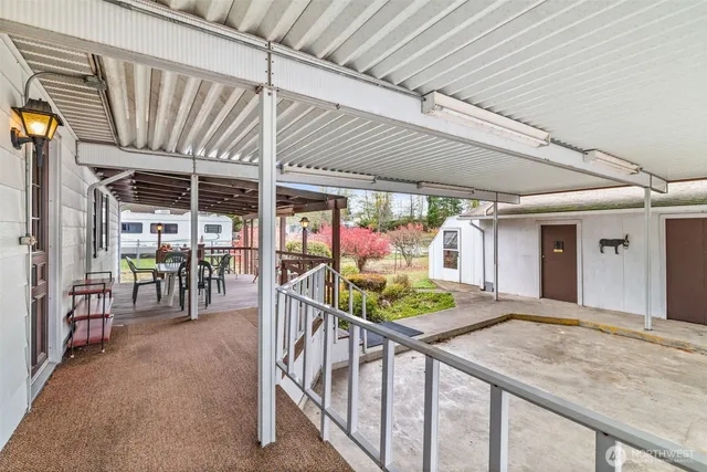 a view of a chairs and table in the balcony