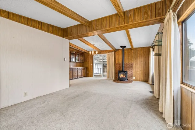 a view of a room with large windows and furniture