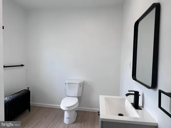 a white toilet sitting next to a bathroom sink