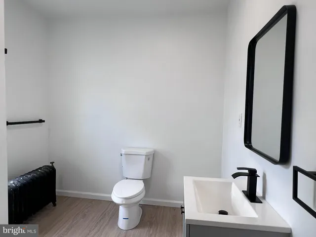 a white toilet sitting next to a bathroom sink