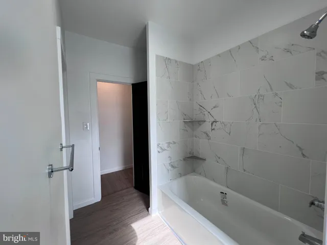 a bathroom with a bathtub and shower