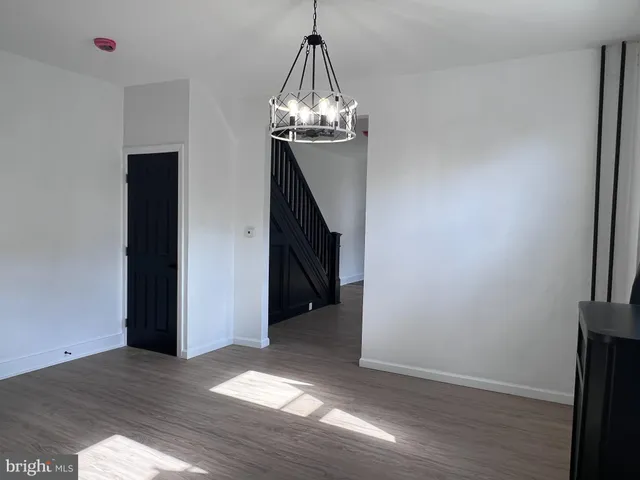 a view of a room with wooden floor and stairs