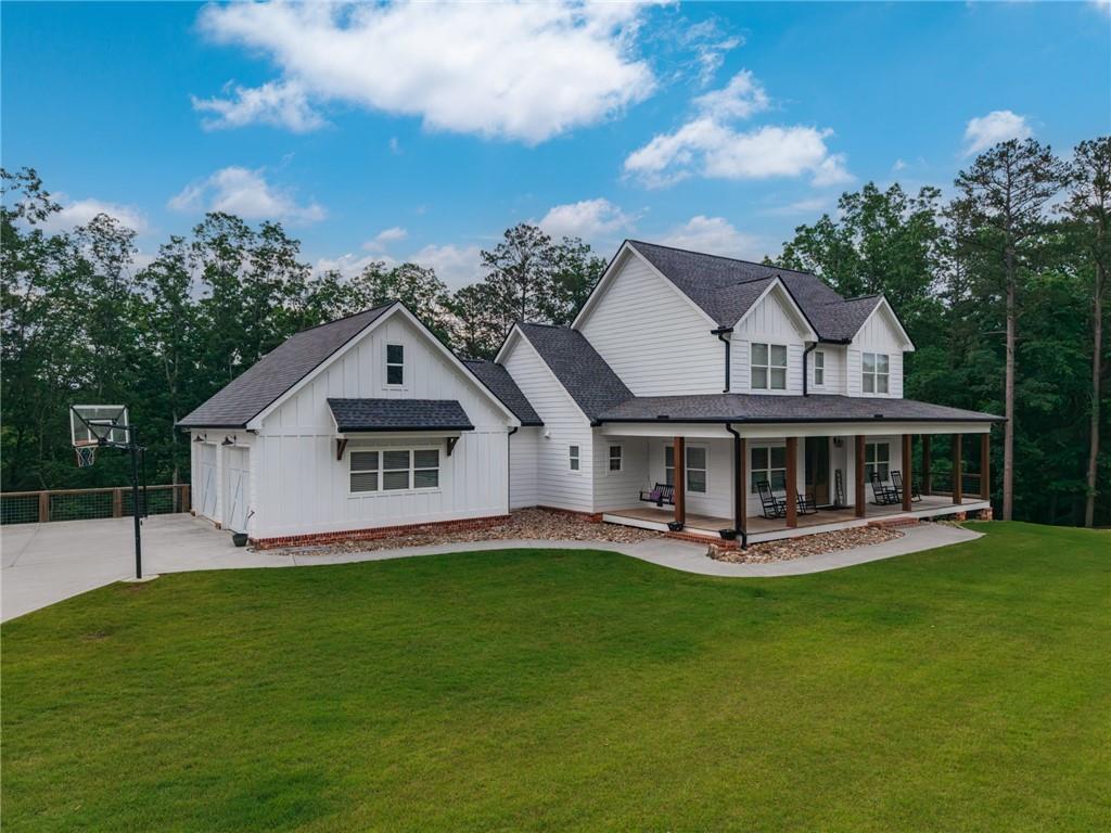 2250 Sperin Road Ball Ground, GA 30107 - Photo 2 of 56 a view of house with a garden