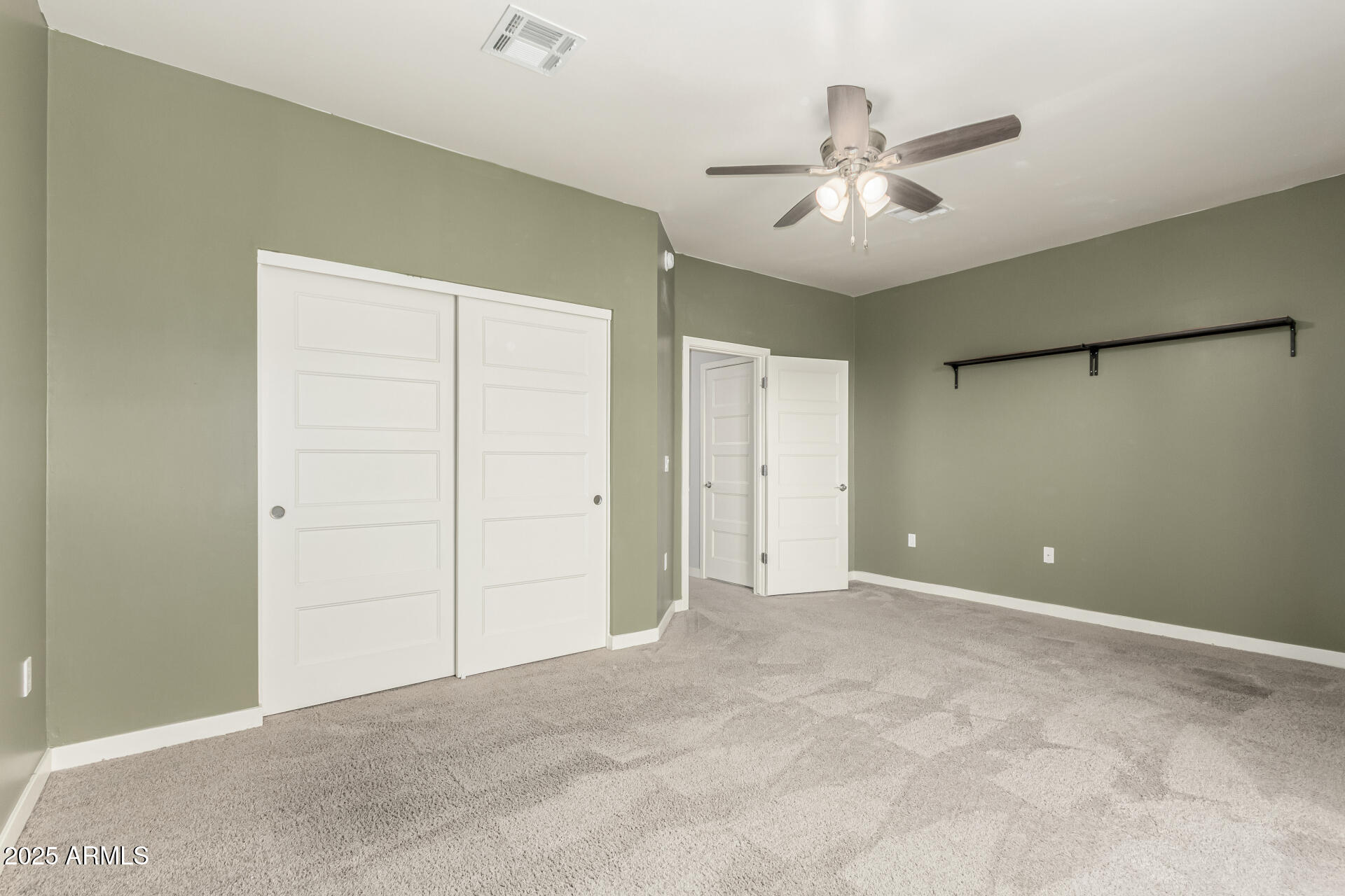 1056 North Miller Road Tempe, AZ 85288 - Photo 16 of 46 a view of an empty room with a ceiling fan