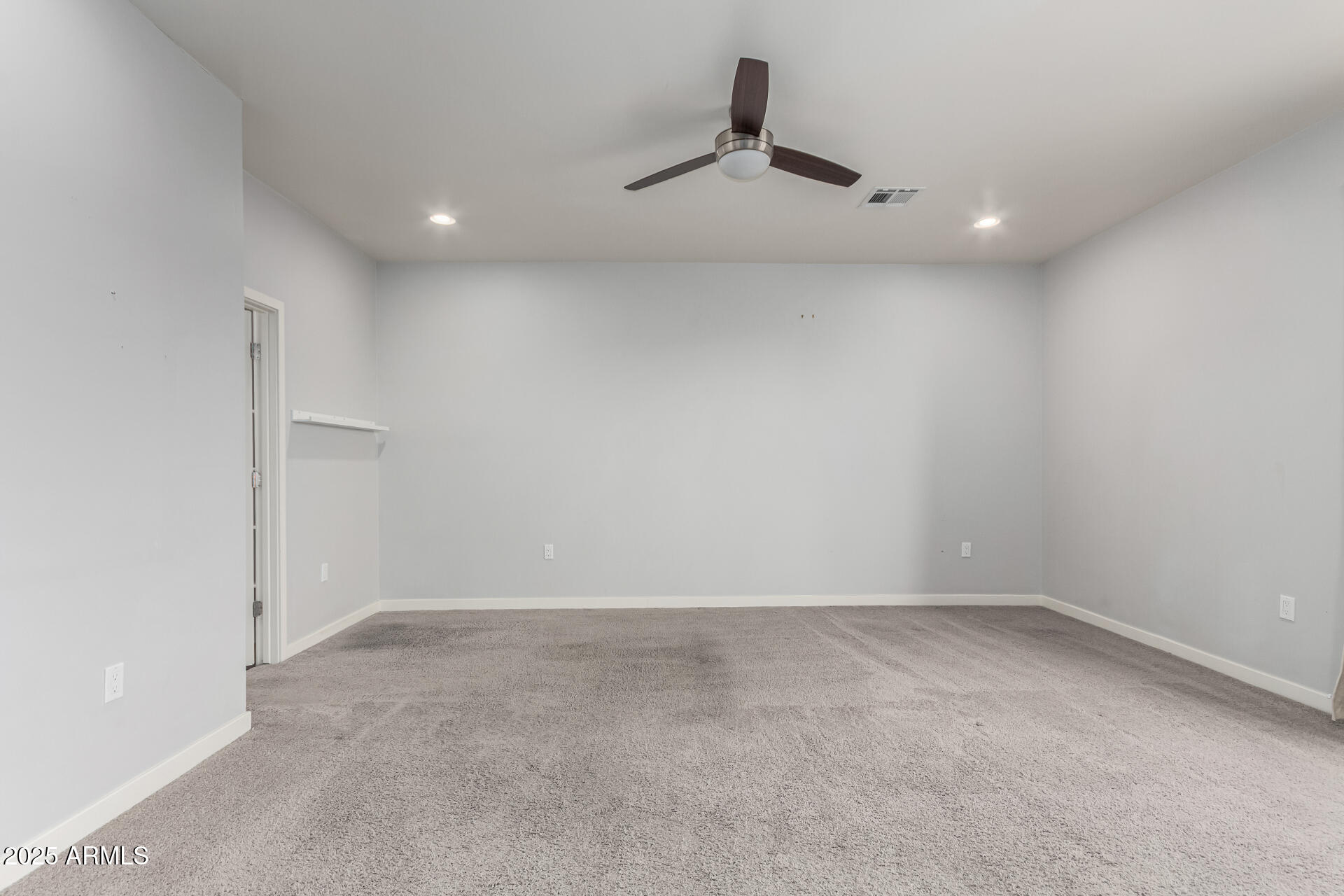 1056 North Miller Road Tempe, AZ 85288 - Photo 19 of 46 an empty room with a ceiling fan and window