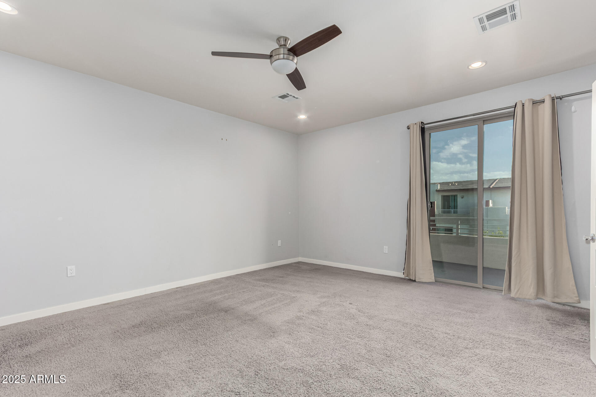 1056 North Miller Road Tempe, AZ 85288 - Photo 20 of 46 an empty room with a window and a ceiling fan