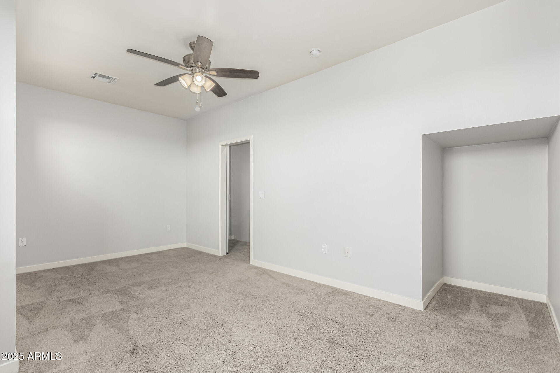 1056 North Miller Road Tempe, AZ 85288 - Photo 21 of 46 an empty room with a ceiling fan and a window