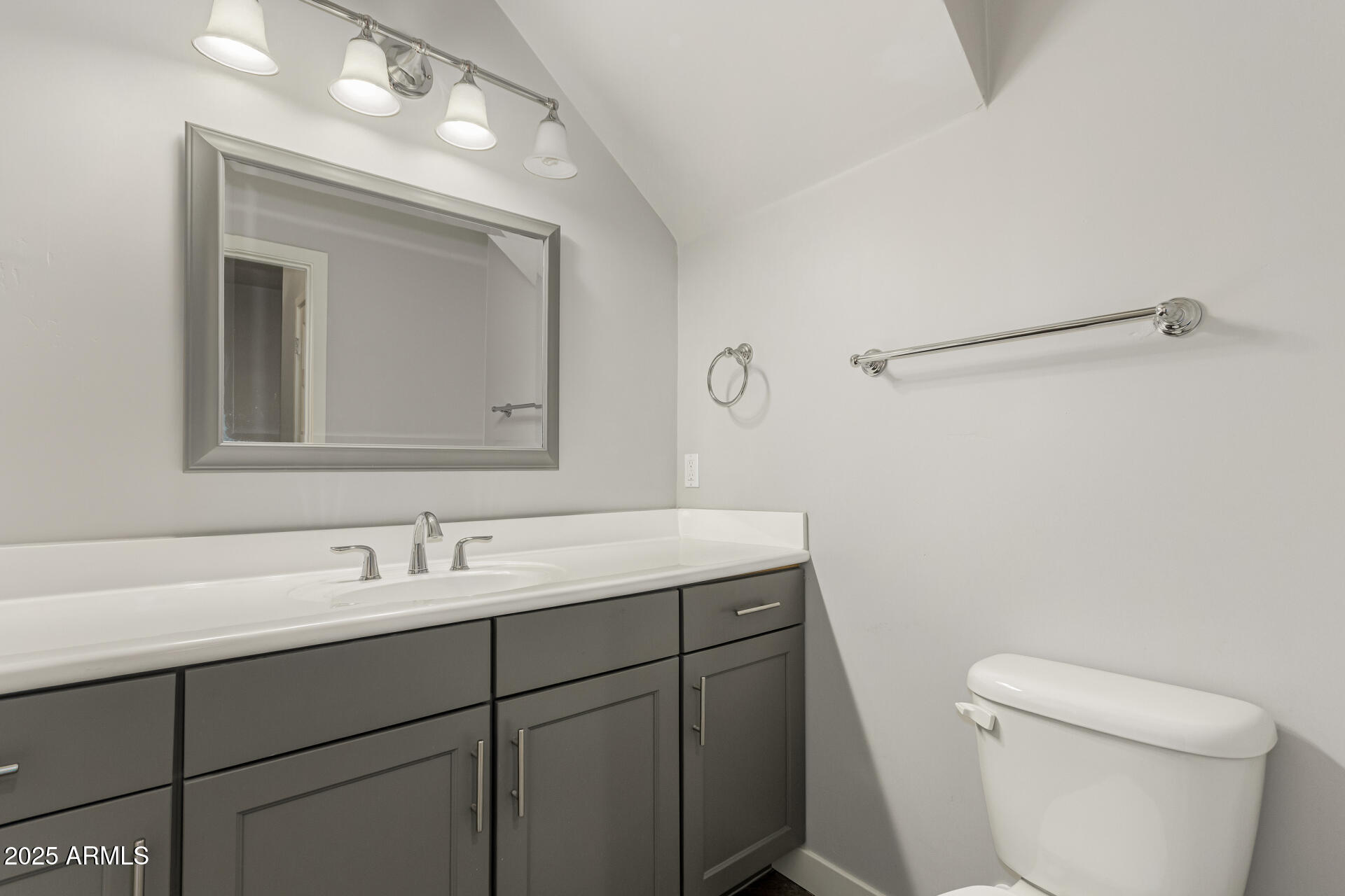 1056 North Miller Road Tempe, AZ 85288 - Photo 25 of 46 a bathroom with a toilet sink and mirror