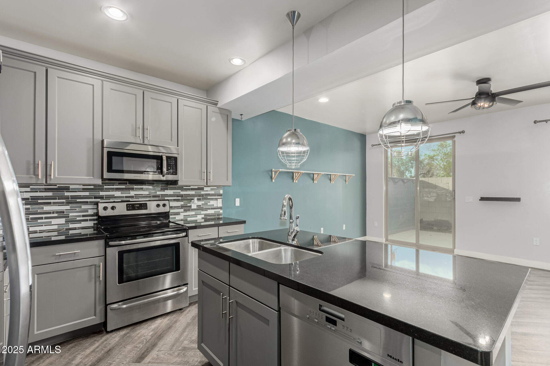 1056 North Miller Road Tempe, AZ 85288 - Photo 3 of 46 a kitchen with a sink stainless steel appliances and cabinets