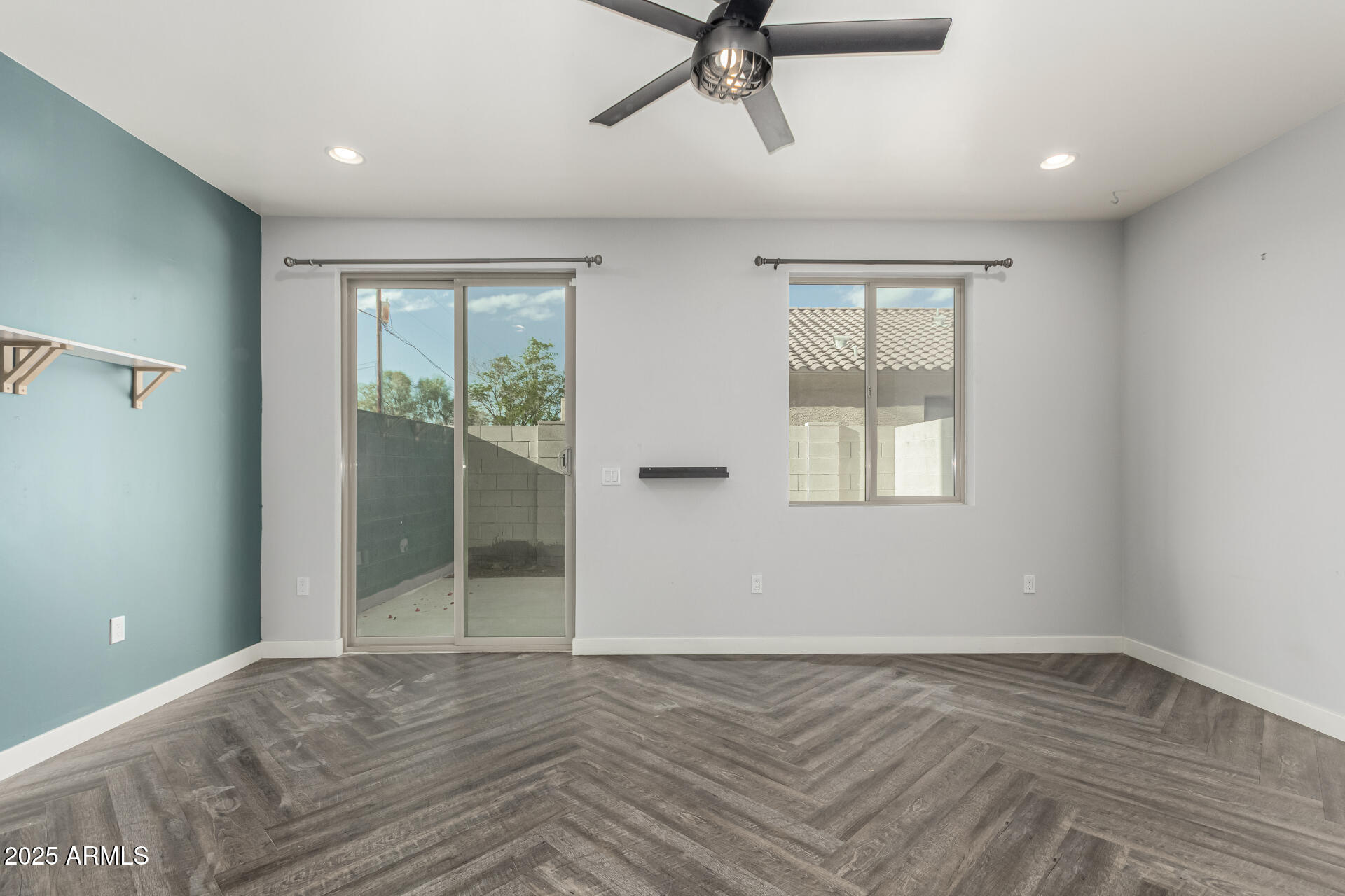 1056 North Miller Road Tempe, AZ 85288 - Photo 5 of 46 a view of empty room with wooden floor and fan